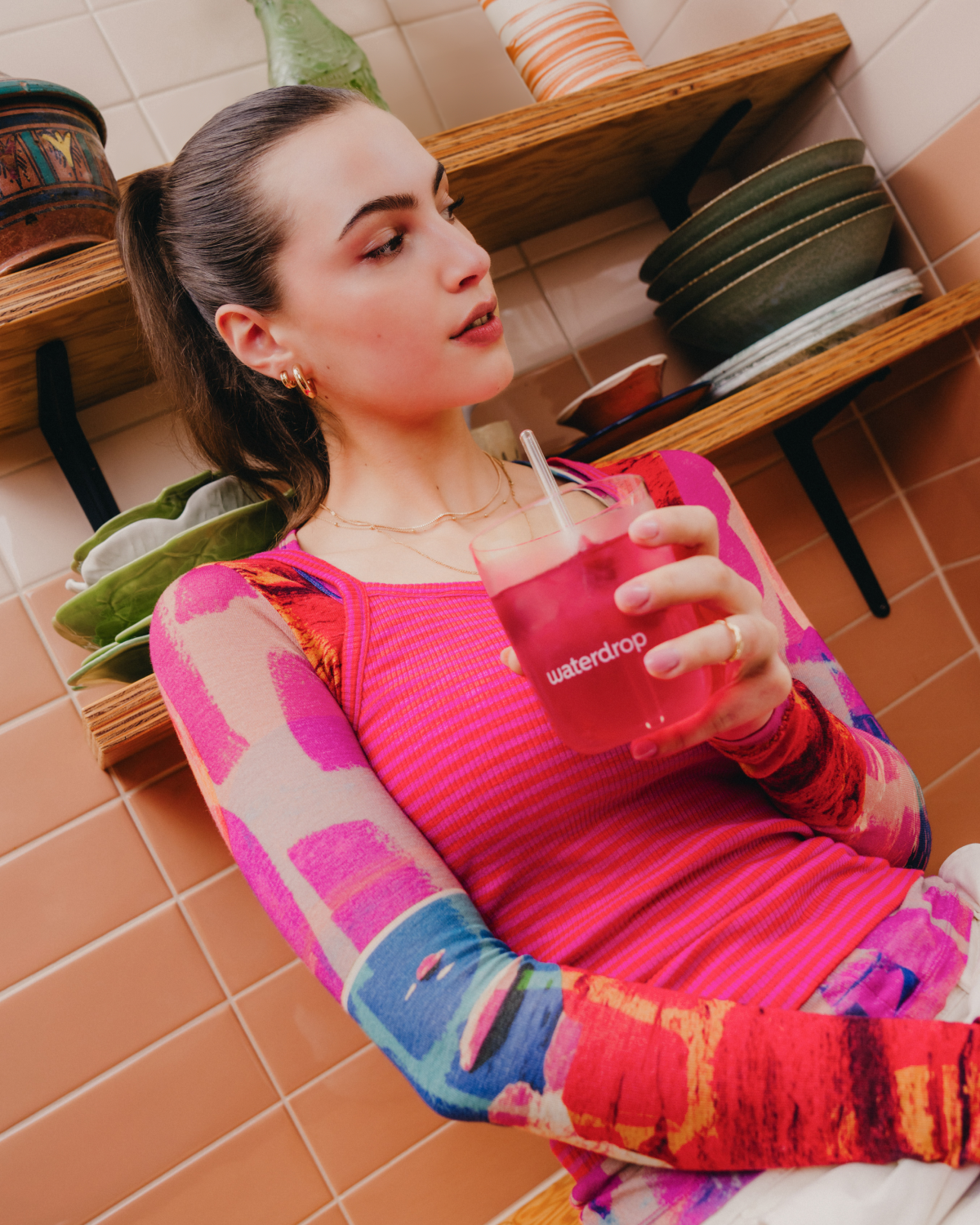 Woman enjoying FRAMBOISE Microdrink indoors.