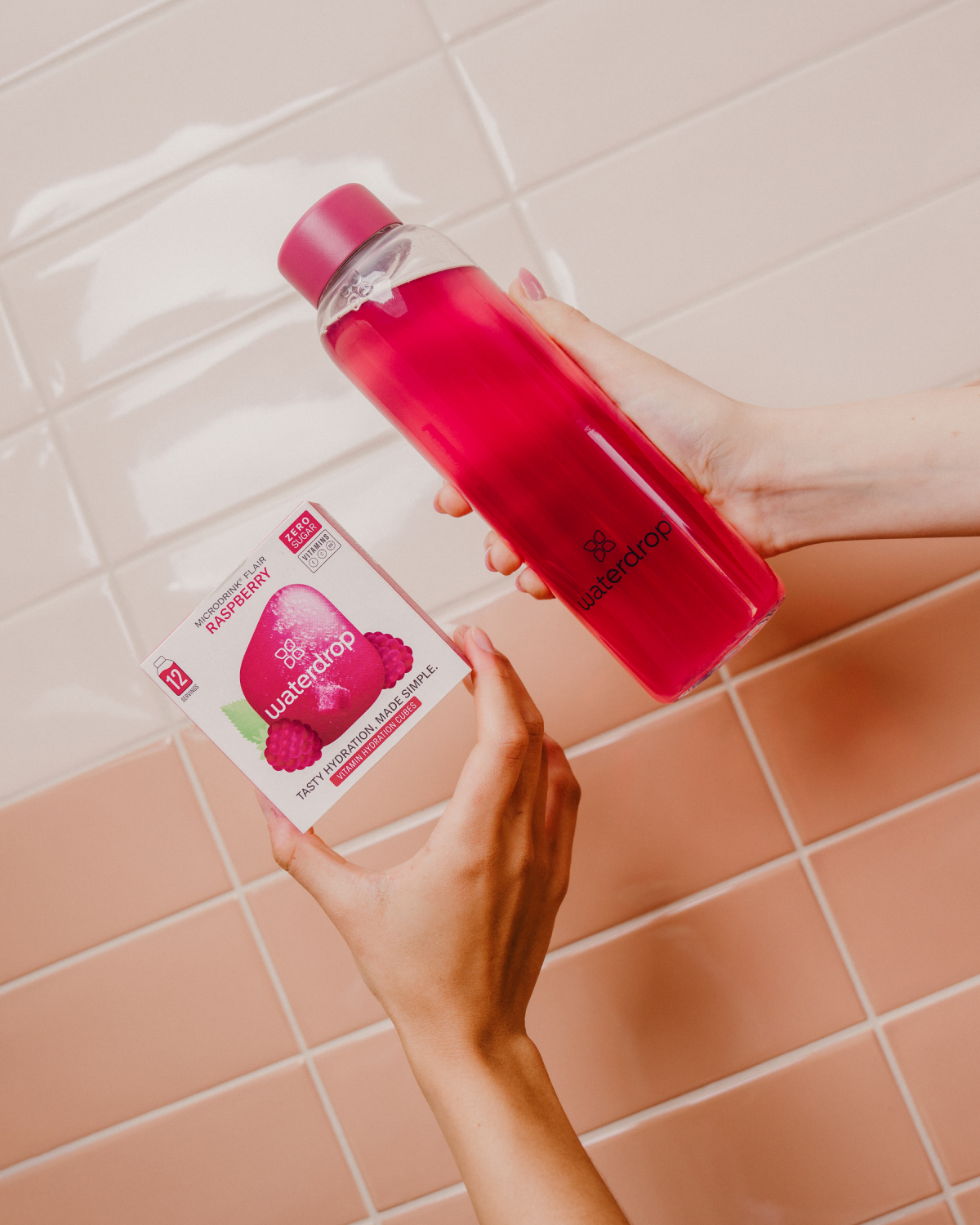 FRAMBOISE Microdrink bottle and box held in hand.