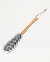 Bottle brush with wooden handle for cleaning.