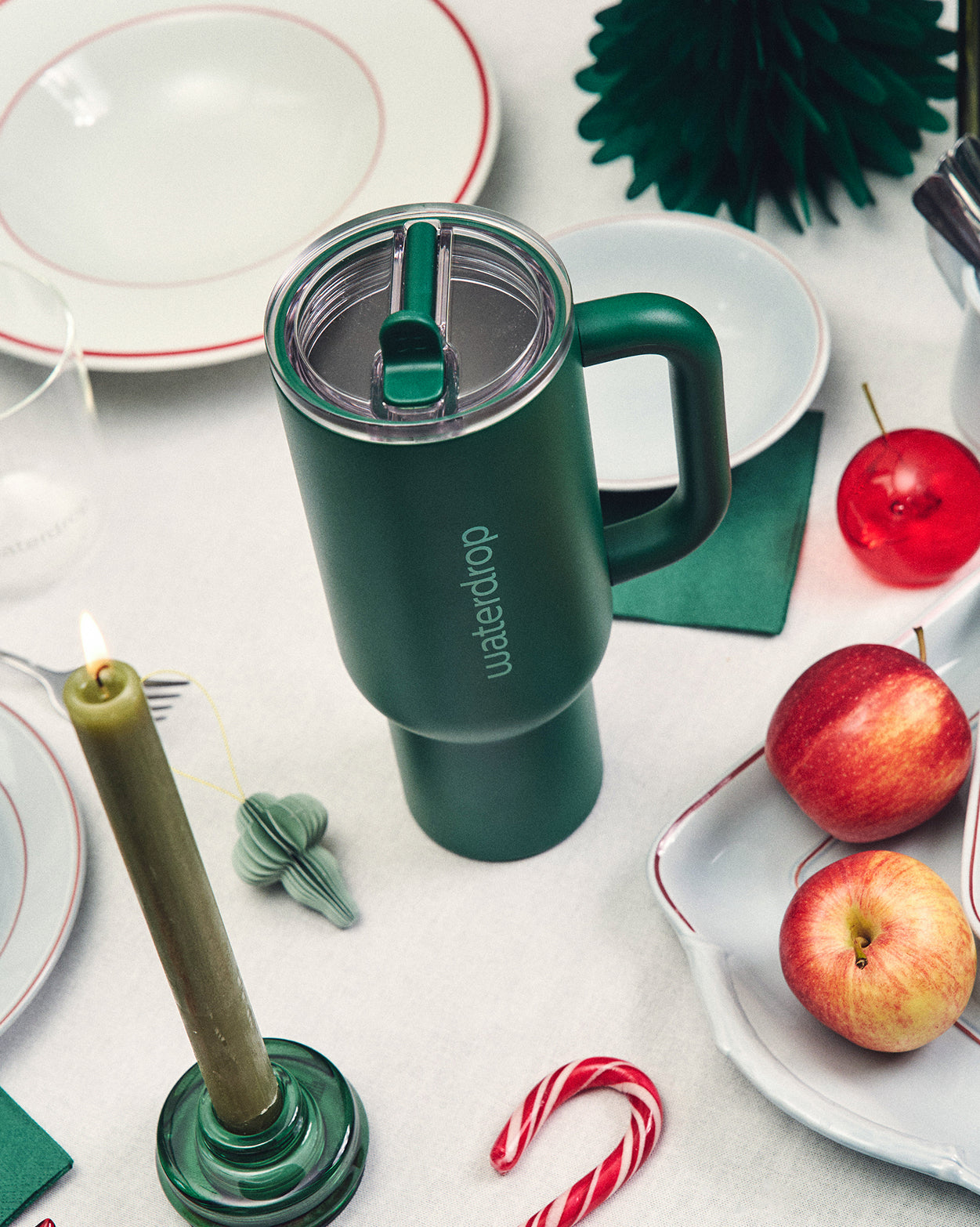 Naughty or Nice Hydration Set green travel mug on festive table.