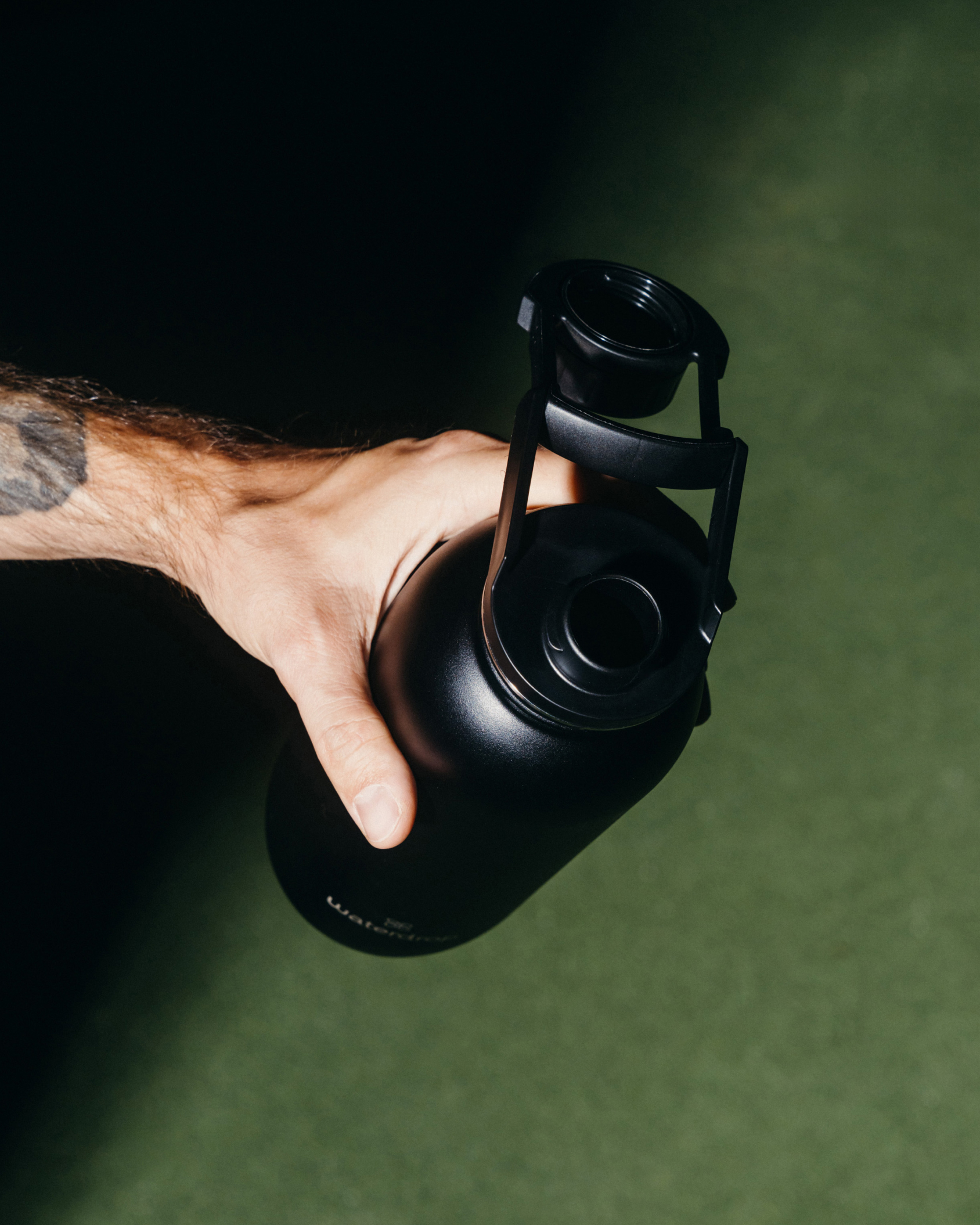 All-Purpose Ultralight · Swing Lid bottle held over turf.