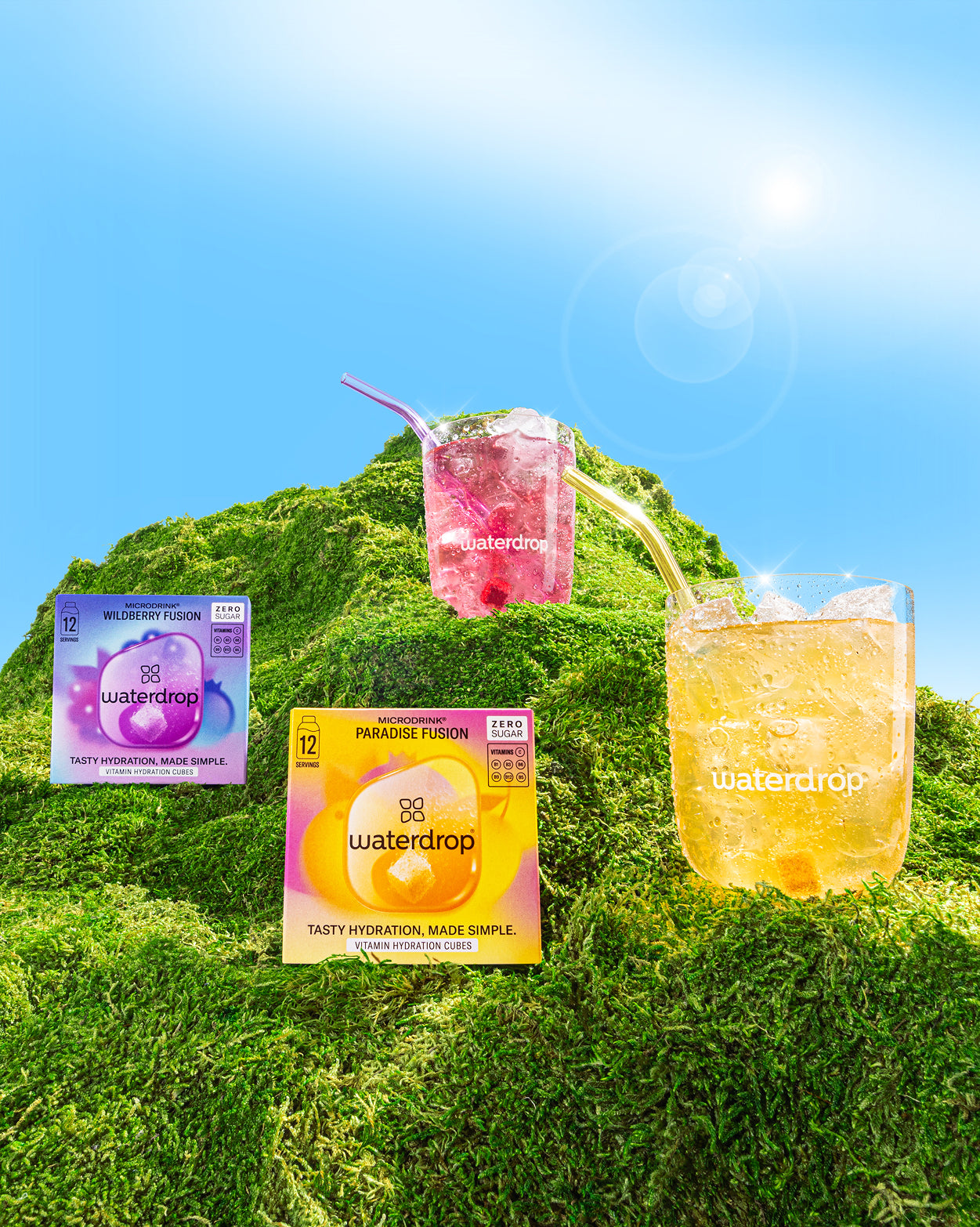 Coffret Un été parfait drink selection on grassy hill.