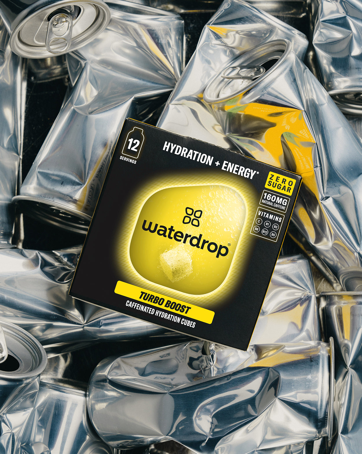 TURBO BOOST caffeinated hydration cubes atop crumpled cans.