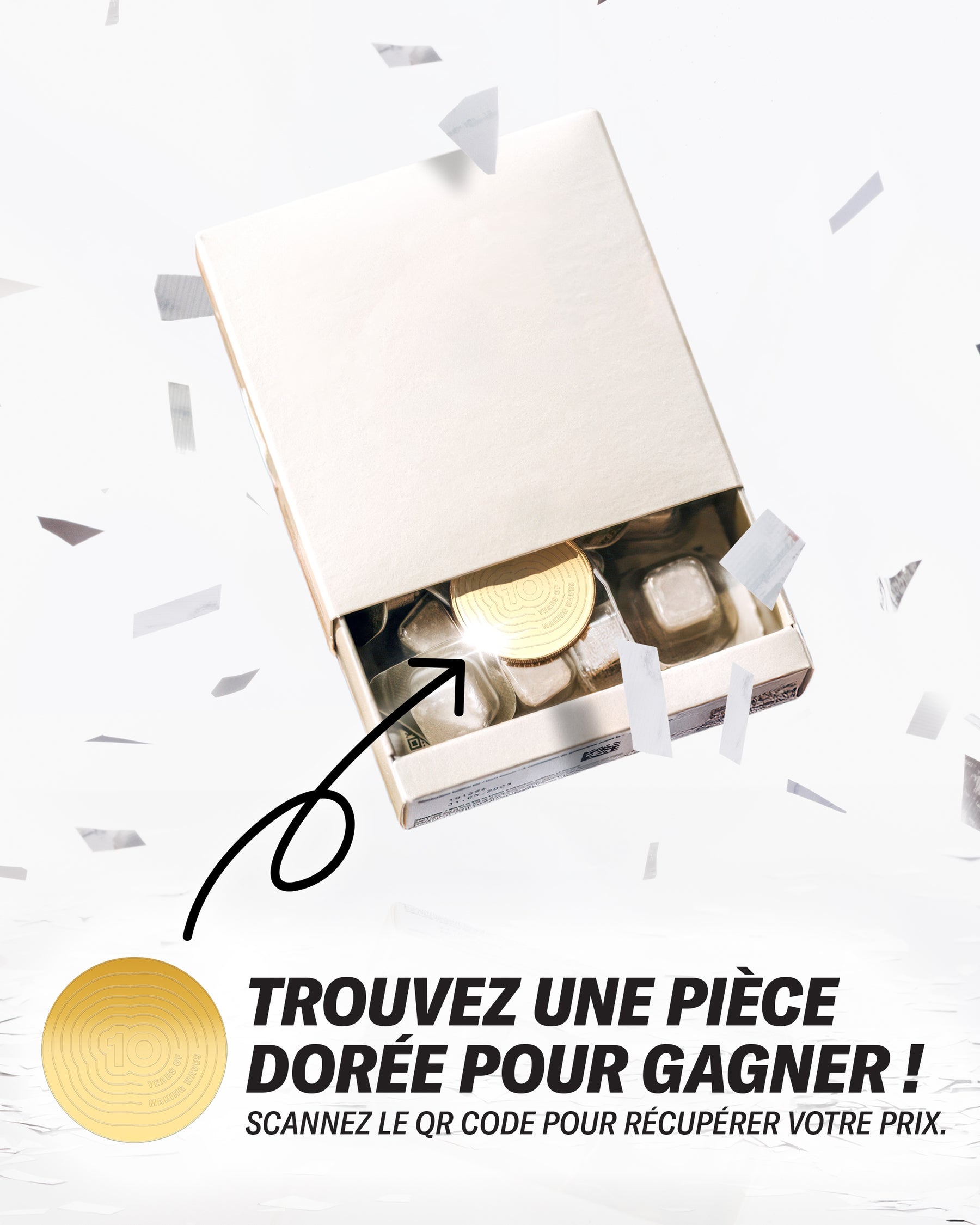 Boîte blanche ouverte avec des pièces d’or et des confettis, suggérant une remise ou récompense.