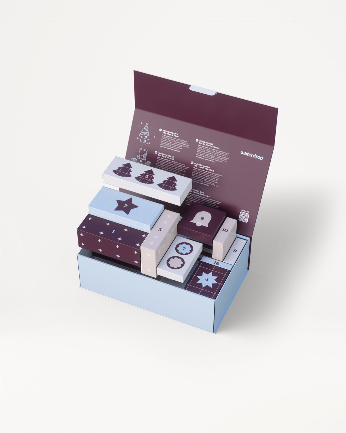 Boîte cadeau à trois niveaux bleu clair avec couvercle violet ouvert pour révéler plusieurs petites boîtes décoratives assorties.