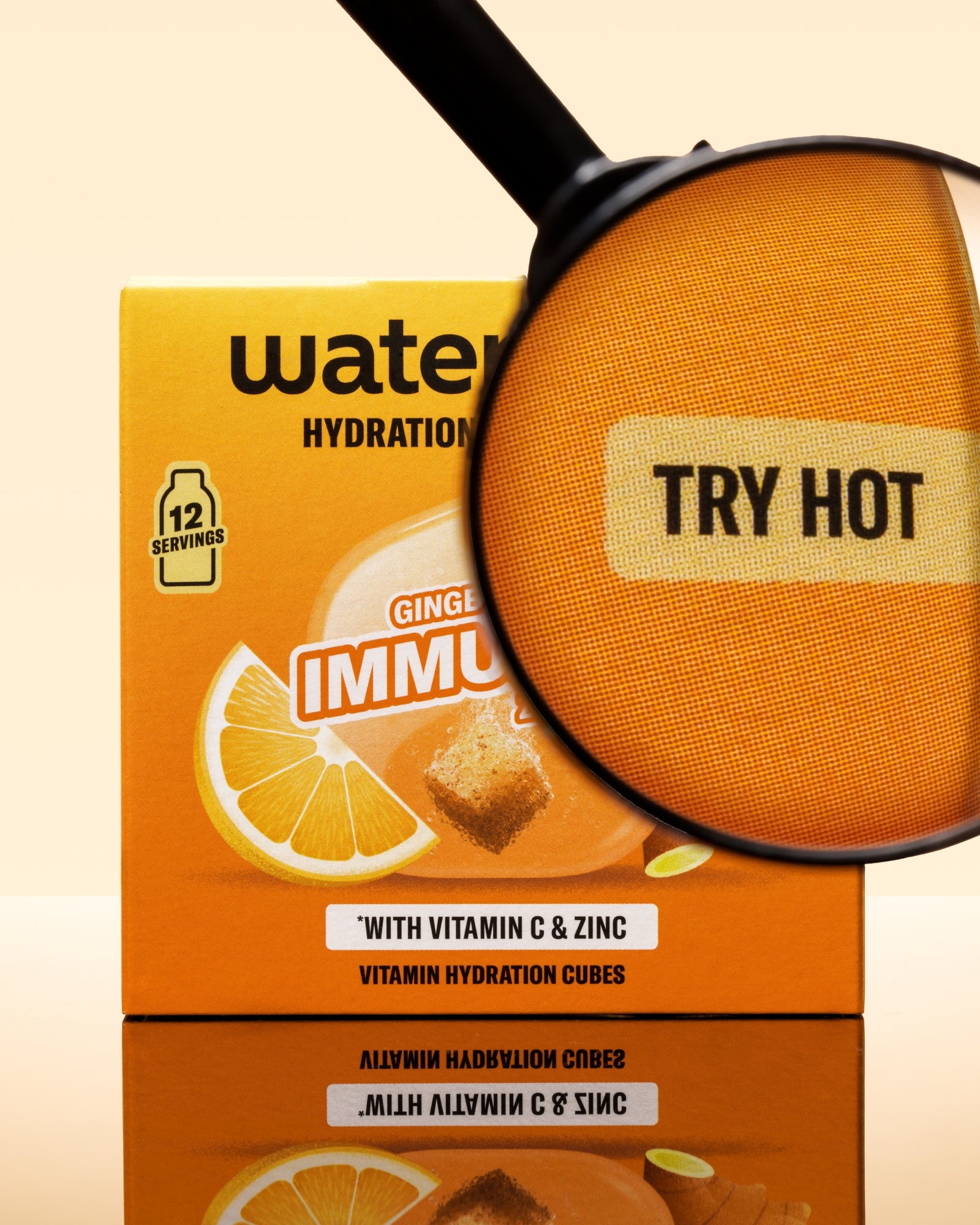 Boîte orange de cubes d'hydratation avec des images de citron et une loupe au-dessus de l'emballage.