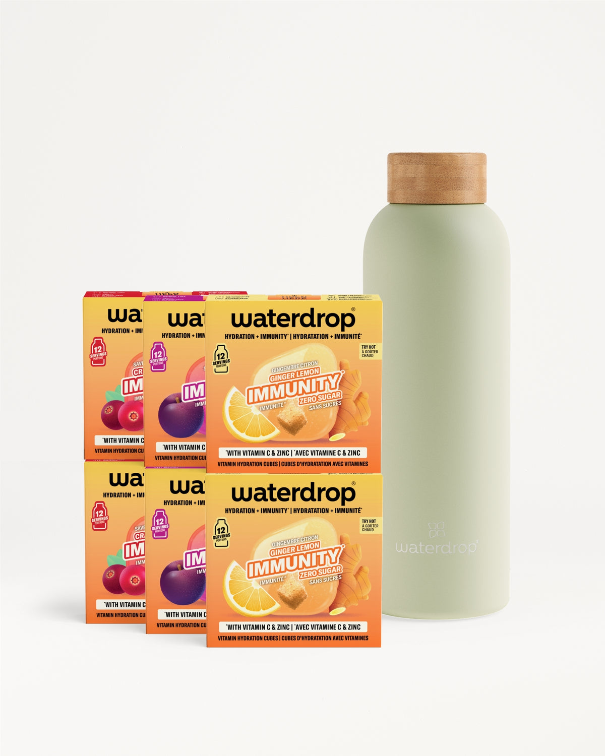 Six boîtes orange de mélange pour boisson disposées à côté d'une bouteille vert clair avec bouchon en liège.