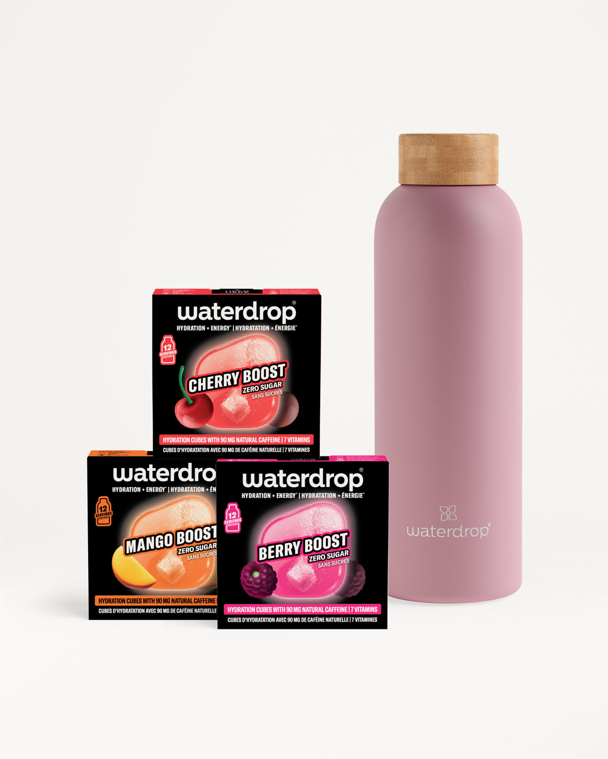 Trois boîtes Flavor Boost et une gourde réutilisable rose avec bouchon en bois.