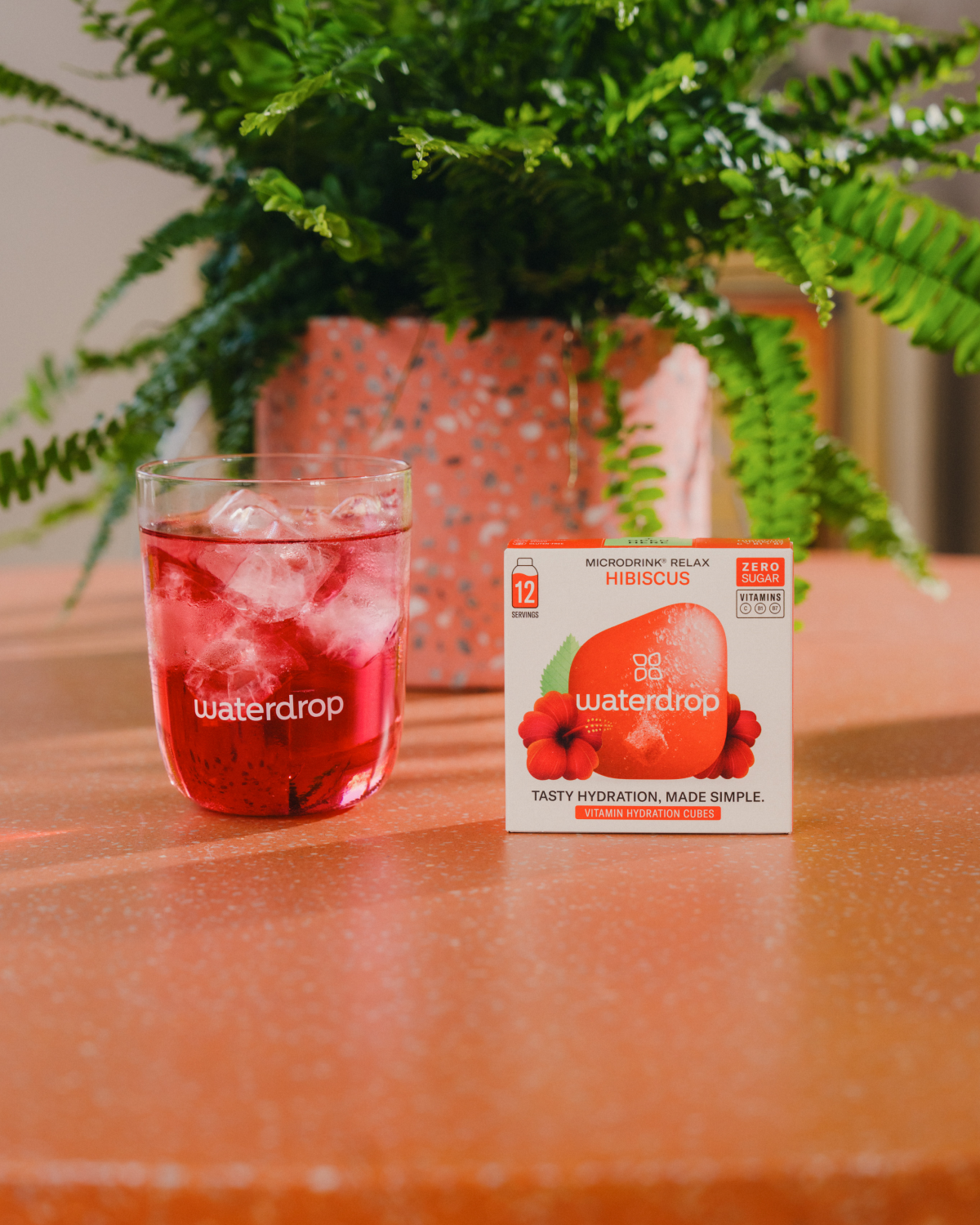 Double Pack HIBISCUS Microdrink with iced beverage and box.