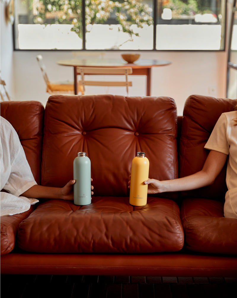 Bouteille Thermo Inox on a brown sofa.